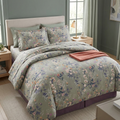 Sage Blossom 7 Piece Comforter Set with white cherry blossoms lavender wildflowers and blush buds on soft sage green background styled on a luxury bed