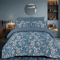 Steel Blue Floral Vine 7 Piece Comforter Set with trailing white daisy blooms and blush tulips on steel blue denim background styled on a luxury bed