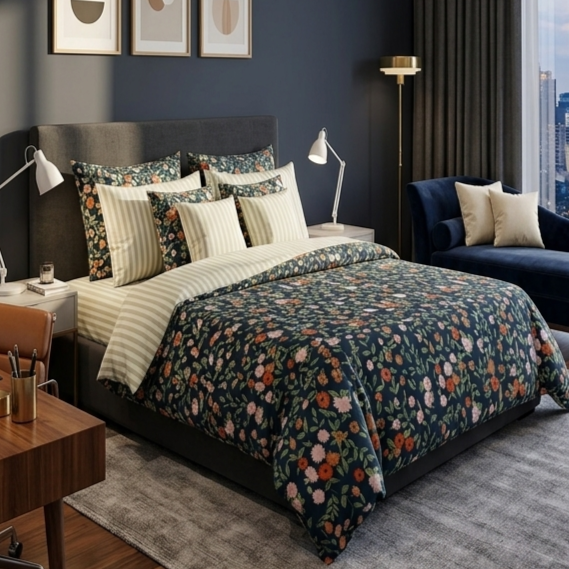 Navy Botanical Garden 7 Piece Comforter Set with blush peonies coral blooms and white wildflowers on deep navy teal background with cream gold pinstripe pillows styled on a luxury bed