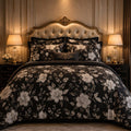 Black Ivory Bloom 7 Piece Comforter Set with large luminous ivory and champagne gold hibiscus blooms and silver grey leaves on jet black background styled in a grand baroque luxury bedroom