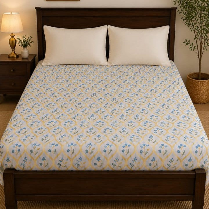 Blue Cornflower Bedsheet Set with scattered tiny blue cornflowers and yellow stems on white background styled on a luxury bed