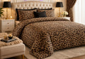 Golden Leopard Print 7 Piece Comforter Set with classic dark brown and black leopard rosette spots on rich golden-brown background with solid black pillow covers styled in a gold-black luxury bedroom