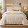 Cream Ditsy Floral Bedsheet Set with all-over tiny scattered sage-green leaf sprigs and blush pink buds on warm cream ivory background styled in a Scandinavian cottage luxury bedroom