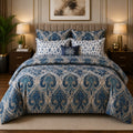Navy Baroque Medallion 7 Piece Comforter Set with grand large-scale Baroque damask medallion in silver-grey ivory and champagne gold on deep navy sapphire background styled in a warm gold luxury bedroom