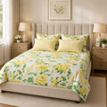 Yellow Peony Garden 7 Piece Comforter Set with large watercolour yellow peonies and green leaves on crisp white background with yellow gingham pillow covers styled in a warm Scandinavian luxury bedroom