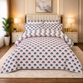 Navy Carnation Fan 7 Piece Comforter Set with repeating navy slate-blue fan carnation blooms and blush pink accents on white with pink grey chevron pillow covers styled in a warm gold luxury bedroom