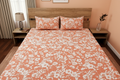 Peach Blossom Bedsheet Set styled on a luxury bed in an elegant bedroom